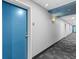 Hallway with decorative lighting and neutral decor leading to unit 909 at 1208 E Kennedy Blvd # 1019, Tampa, FL 33602