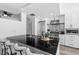 Bright kitchen features black granite counters, stainless steel appliances, and modern white cabinetry at 1208 E Kennedy Blvd # 1019, Tampa, FL 33602