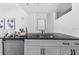 Close-up of kitchen features black granite counters, stainless steel appliances, and white cabinetry at 1208 E Kennedy Blvd # 1019, Tampa, FL 33602