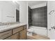 Bathroom featuring a granite vanity and a tiled shower-tub at 13065 Tinamou Ave, Weeki Wachee, FL 34614