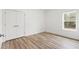 Bright bedroom with wood-look floors and a window view to the outdoors at 13065 Tinamou Ave, Weeki Wachee, FL 34614