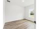 Bright bedroom with wood-look floors and a window view to the outdoors at 13065 Tinamou Ave, Weeki Wachee, FL 34614