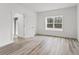 Bright bedroom features wood-look floors and a large window overlooking a wooded area at 13065 Tinamou Ave, Weeki Wachee, FL 34614