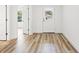 Bright hallway with white walls and doors and wood-look floors at 13065 Tinamou Ave, Weeki Wachee, FL 34614
