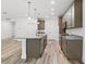 Modern kitchen design with granite counters, stainless appliances, and wood-look flooring at 13065 Tinamou Ave, Weeki Wachee, FL 34614