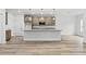 Bright kitchen with granite counters, stainless appliances, pendant lighting, and wood-look flooring at 13065 Tinamou Ave, Weeki Wachee, FL 34614