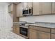 Kitchen with stainless steel appliances and granite counters at 13065 Tinamou Ave, Weeki Wachee, FL 34614