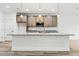 Kitchen island with granite countertops and pendant lighting in modern kitchen at 13065 Tinamou Ave, Weeki Wachee, FL 34614