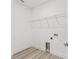 Clean and bright laundry room featuring tile flooring and ample shelving for storage at 13065 Tinamou Ave, Weeki Wachee, FL 34614