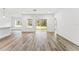 Bright living room with wood-look floors and sliding glass doors leading to the outdoors at 13065 Tinamou Ave, Weeki Wachee, FL 34614