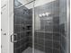 Modern tiled shower with built-in shelves and glass door at 13065 Tinamou Ave, Weeki Wachee, FL 34614