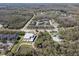 Aerial view of community with townhomes, playground, and community center close to wooded areas at 1308 Syrah Dr, Oldsmar, FL 34677