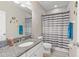 Bathroom with grey granite counters, tiled floor, shower with tub and white vanity at 1308 Syrah Dr, Oldsmar, FL 34677