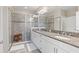 Bathroom featuring white cabinets, granite counters, glass shower and tile floors at 1308 Syrah Dr, Oldsmar, FL 34677