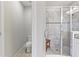 Bathroom featuring white tiled shower, toilet and white walls at 1308 Syrah Dr, Oldsmar, FL 34677