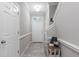 Spacious foyer with a decorative table, white door, grey tile floor, and natural lighting at 1308 Syrah Dr, Oldsmar, FL 34677