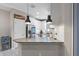 Bright kitchen with granite countertop bar, white cabinets, stainless steel appliances, and recessed lighting at 1308 Syrah Dr, Oldsmar, FL 34677
