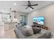 Comfortable living room boasts a sectional sofa, ceiling fan, and sliding glass doors to the outdoor patio at 1308 Syrah Dr, Oldsmar, FL 34677