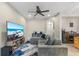 Inviting living room with comfortable seating, a ceiling fan, and an arched doorway to the hallway and kitchen at 1308 Syrah Dr, Oldsmar, FL 34677