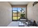Enclosed patio featuring outdoor seating and a view of the backyard's lush landscaping and privacy fence at 1308 Syrah Dr, Oldsmar, FL 34677