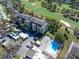 An aerial view shows the building next to a golf course, swimming pool, and shuffleboard court at 13618 Greenfield Dr # 406, Tampa, FL 33618