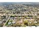 An aerial view depicts a quiet residential neighborhood, with some homes featuring backyard pools at 1369 Whitacre Dr, Clearwater, FL 33764