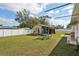 Green backyard with an outdoor shed with seating, perfect for relaxation at 1369 Whitacre Dr, Clearwater, FL 33764