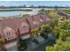 Stunning aerial view of the townhouses with waterfront access and lush greenery, showcasing the community's beauty at 14584 El Paseo Dr, Seminole, FL 33776