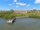 Waterfront condo featuring a private dock on serene waters surrounded by lush greenery at 14584 El Paseo Dr, Seminole, FL 33776