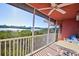 Screened balcony with calming water views, table, chairs, and ceiling fan is the perfect outdoor retreat at 14584 El Paseo Dr, Seminole, FL 33776