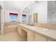 Bright bathroom featuring double sinks, soaking tub, and separate shower area offers a luxurious feel at 14584 El Paseo Dr, Seminole, FL 33776
