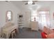 Bright bedroom with a wicker vanity, shelving, and coral-themed decor at 14584 El Paseo Dr, Seminole, FL 33776