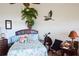 Comfortable bedroom featuring a decorative bird statue, a telescope, and a tropical-themed comforter for a tranquil setting at 14584 El Paseo Dr, Seminole, FL 33776