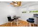 Cozy breakfast nook with wood floors, ceiling fan, and natural light from the window at 14584 El Paseo Dr, Seminole, FL 33776