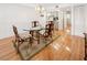 Light-filled dining room with a glass table, seating for four, and a mirrored bar area at 14584 El Paseo Dr, Seminole, FL 33776