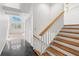 Home entryway featuring staircase with wood trim and black tile leading to the living room at 14584 El Paseo Dr, Seminole, FL 33776