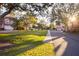 Manicured lawns with sidewalk and mature trees enhance community charm at 14584 El Paseo Dr, Seminole, FL 33776