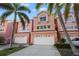 Charming townhome with lush landscaping, covered garages, and a welcoming facade at 14584 El Paseo Dr, Seminole, FL 33776