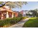 Charming home with covered porch, lush landscaping, and inviting walkway at 14584 El Paseo Dr, Seminole, FL 33776