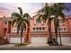 Attractive townhomes feature multi-car garages, palm trees, and well-maintained landscaping at 14584 El Paseo Dr, Seminole, FL 33776