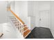Bright foyer showcasing tile floors, wooden stairs, and a front door entry at 14584 El Paseo Dr, Seminole, FL 33776