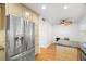 Bright kitchen featuring stainless steel appliances, wood cabinets, granite countertops, and hardwood floors at 14584 El Paseo Dr, Seminole, FL 33776