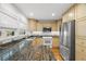 Well-lit kitchen with stainless steel appliances, granite countertops, and ample cabinet space for storage at 14584 El Paseo Dr, Seminole, FL 33776