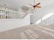 Open-concept living area with stairs and natural light coming in from windows at 14584 El Paseo Dr, Seminole, FL 33776
