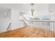 Bright loft with hardwood floors, staircase, and large windows, creating an open and airy living space at 14584 El Paseo Dr, Seminole, FL 33776