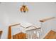 Staircase with hardwood steps, white railing and lots of natural light at 14584 El Paseo Dr, Seminole, FL 33776