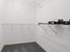 Empty walk-in closet, featuring wire shelving and neutral carpet at 14584 El Paseo Dr, Seminole, FL 33776