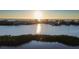 Scenic waterfront community view at sunset, reflecting golden sunlight across the tranquil waters at 14584 El Paseo Dr, Seminole, FL 33776