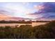 Stunning waterfront community view at sunset, showcasing a beautiful and serene residential area at 14584 El Paseo Dr, Seminole, FL 33776