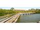 Elevated wooden walkway offering scenic water views, connecting the community with nature and tranquility at 14584 El Paseo Dr, Seminole, FL 33776